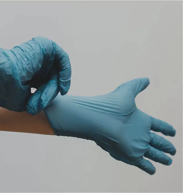 professional putting on medical gloves