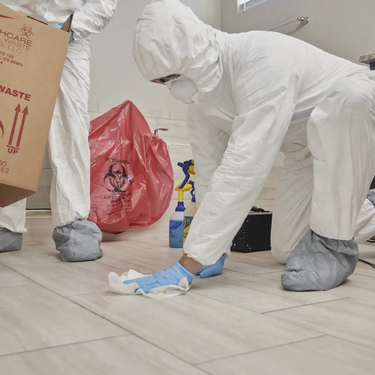 professional technical cleaners disinfecting bathroom floor